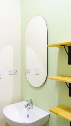 a bathroom with a sink and a mirror at Selva House in Medellín