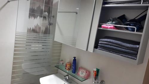 a bathroom with a sink and a mirror above a sink at Blue Ocean House in Ulsan