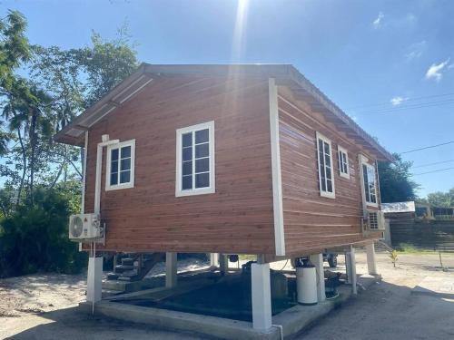 a house that is sitting on a foundation at Cashew Tree Cabana - Small Cosy, Close to the Beach. in Placencia Village