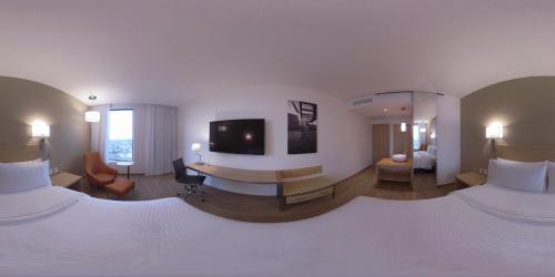 a hotel room with two beds and a television at Fiesta Inn Parque Puebla in Puebla