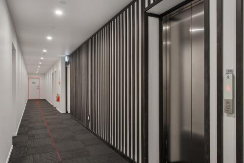 a hallway with black and white walls and a red line at Heart of the CBD 2Bdrms 2Bthrms secure park in Christchurch