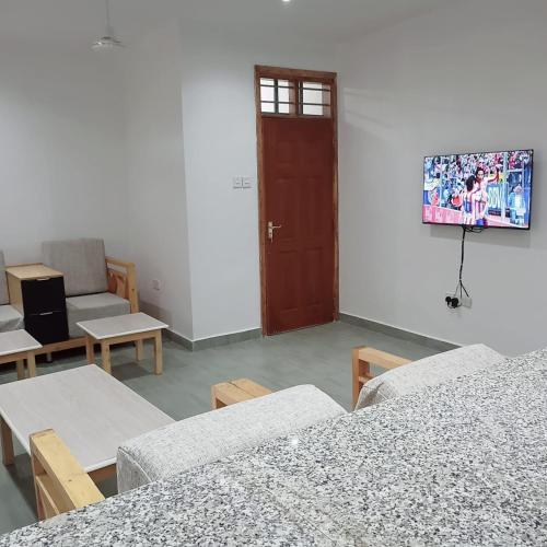 a room with tables and chairs and a door at Jade luxury apartments in Galu