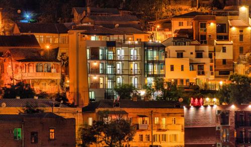 a view of a city at night with buildings at Brooch Boutique Hotel in Tbilisi City