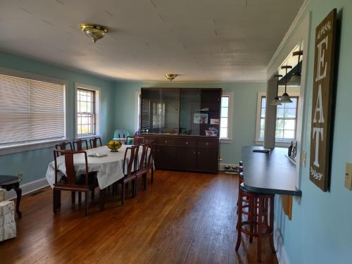 a dining room and kitchen with a table and chairs at Welcome To Downtown Pickens close to Clemson and Lake Keowee in Pickens