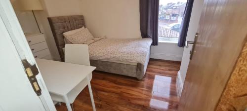 a small bedroom with a bed and a window at Scotland Street, Newton Heath in Manchester