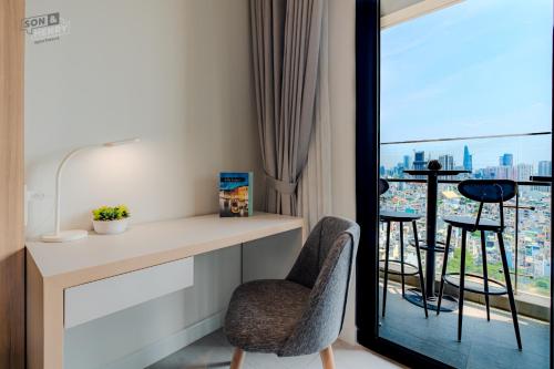 a room with a desk and chairs and a balcony at Son&Henry Zenity District 1 in Ho Chi Minh City
