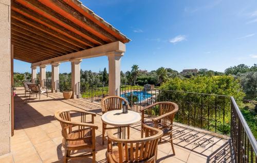 a patio with a table and chairs and a pool at Stunning Home In Manacor in Manacor
