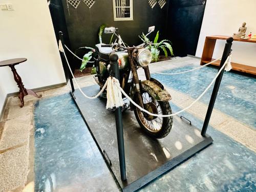 a motorcycle on a stand in a room at Colonial Retreat Villa in Talawatugoda