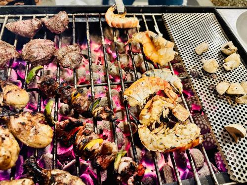 a grill with different types of food on it at Colonial Retreat Villa in Talawatugoda