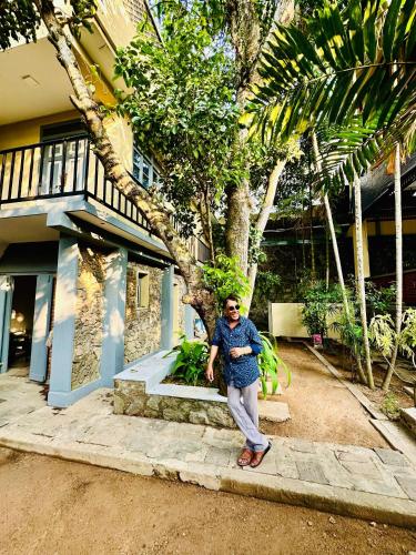 a man standing in front of a house at Colonial Retreat Villa in Talawatugoda