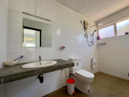 a white bathroom with a sink and a toilet at Dream Hills Villa, Nillambe Kandy in Kandy