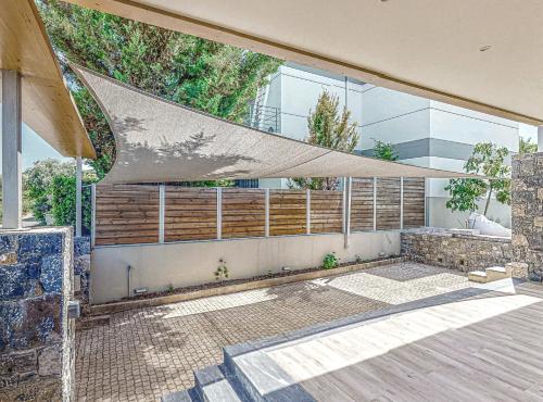 a building with a large window with a net at Villa Salvia - Country style luxury & a captivating poolscape in Áyiai Paraskiaí