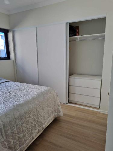 a white bedroom with a bed and a closet at Private Bedroom and Bathroom in a shared Apartment in Gold Coast