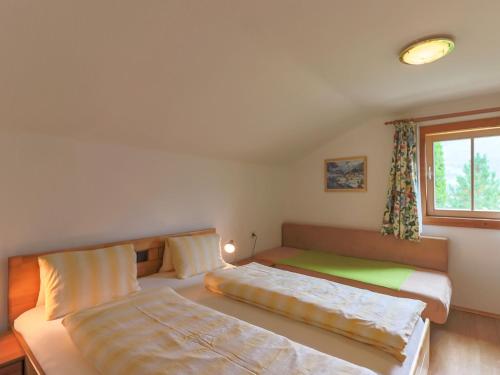 a bedroom with two beds and a window at Chalet in Piesendorf near Ski Slopes in Piesendorf