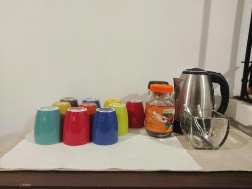 a row of colorful coffee cups sitting on a counter at Blue Moon Hostel in Antigua Guatemala