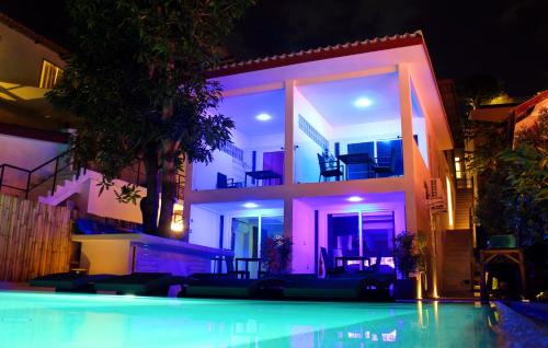 a house with a swimming pool in front of it at night at Mango Tree Villa in Panwa Beach