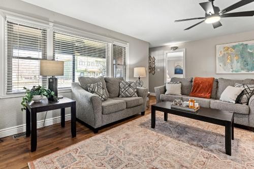 a living room with a couch and a table at Villa Bella elegant family retreat in downtown in Bentonville