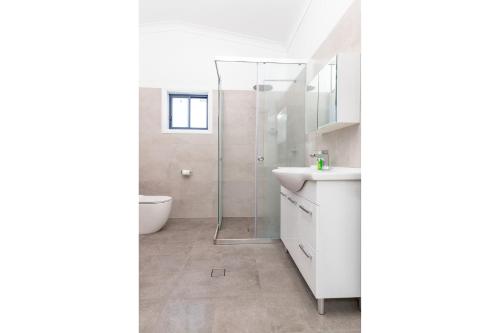 a bathroom with a sink and a shower at Crown Cottage in Smiths Lake