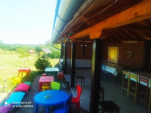 a restaurant with colorful tables and chairs in a field at Dečiji vinogradi Belgrade, Sopot, Kosmaj in Sopot