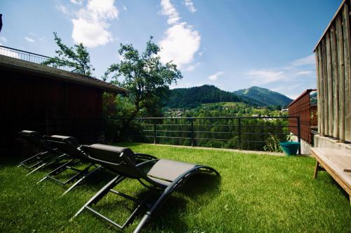 a chair sitting on the grass in a yard at Ride and Breakfast in Montriond