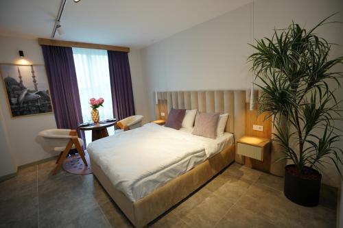 a bedroom with a bed and a potted plant at Dream house 22 in Istanbul