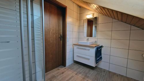 a small bathroom with a sink and a mirror at FeWo Horb Am Neckar in Horb am Neckar