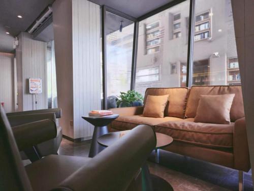 a living room with a couch and a table at Hansen Hotel in Hangzhou