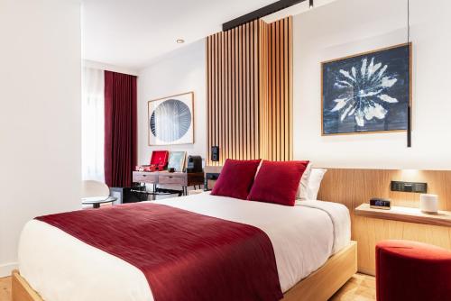 a bedroom with a large bed with red pillows at Boutique Hotel OLOM - Only Adults recommended in Cádiz
