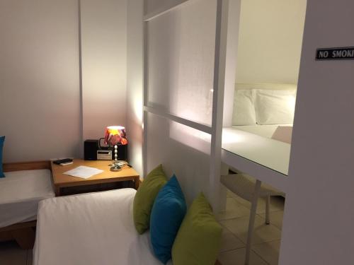 a small room with a bed and a desk with a bed sidx sidx at Possidi Hiliadou Boutique Resort in Possidi