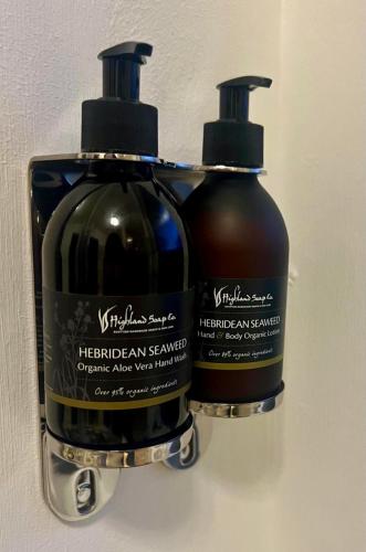 two bottles of shampoo sitting next to each other at Eldon Lea in Strathpeffer