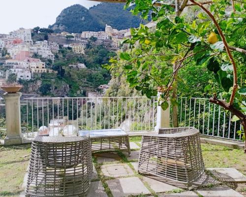 a table and chairs with a view of the city at Villa Stella del mare in Positano