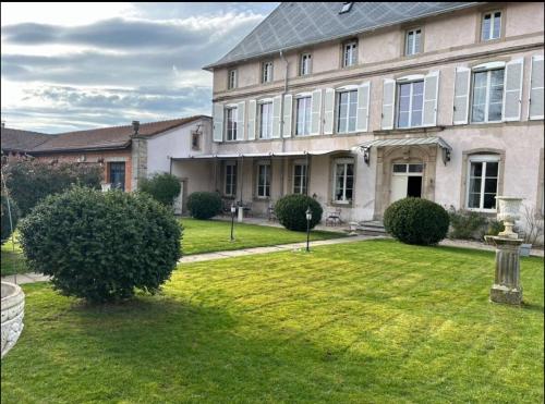 a large house with a lawn in front of it at Le Château de Failloux, Piscine intérieure in Épinal