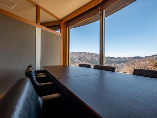 a conference room with a table and chairs with a view at Nagominoyado Hanagokoro - Reopening in Mar 2024 in Hakone