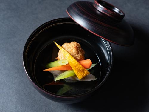 a black bowl of food with vegetables in it at Nagominoyado Hanagokoro - Reopening in Mar 2024 in Hakone