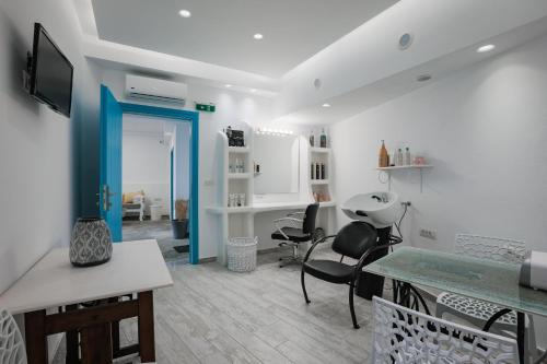 a living room with a blue door and chairs at Nikolas Hotel in Karterados