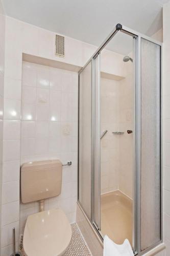 a bathroom with a shower and a toilet at Hotel Garni Traube in Friedrichshafen
