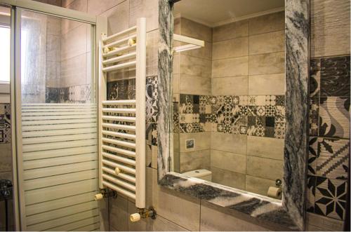 a bathroom with a shower with a mirror at Filippou 13 Luxury APRTS in Thessaloniki