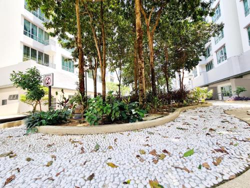 a building with trees and a gravel road at 8 Guest 3 Room Casa Tiara Subang Parade Nu Empire Taylors Campus SJMC Sunway Pyramid Sunway Lagoon Sunway Medical Center in Subang Jaya