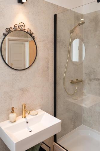a bathroom with a sink and a mirror at Seaside Apartments Pinezic in Malinska
