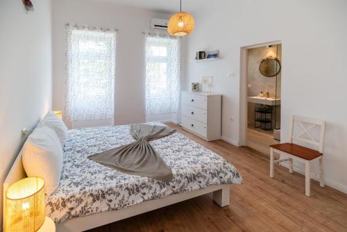 a bedroom with a bed and a dresser and a mirror at Seaside Apartments Pinezic in Malinska