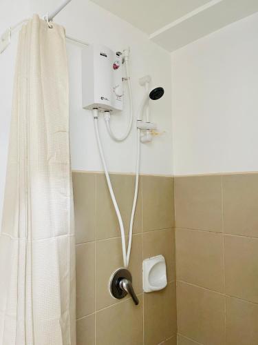 a shower with a white shower curtain in a bathroom at * *D2 Central Location Condo in Iloilo City