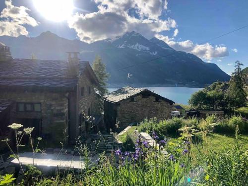 a stone house with a view of a mountain at Chalet 1728 - La Reculaz - 2 minutes from Val D'isere by free shuttle bus in Tignes