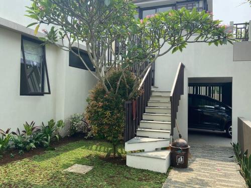 a stairway leading to a house with a tree at Private Villa 3+1BR in Vimala Hills in Gadok 1