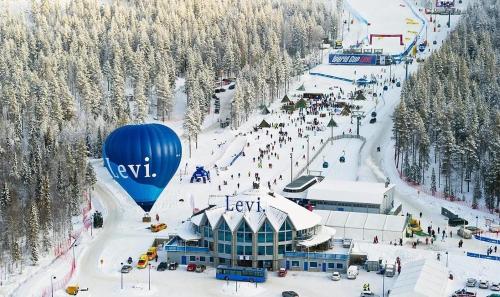 a ski resort with a bunch of people on a ski slope at LEVI Tunturinlaita A4, Ski-in Ski-out 3xBedroom in Levi