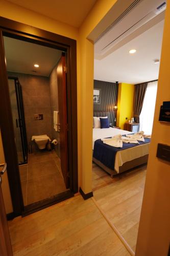 a hotel room with a bed and a bathroom at La Bonita Marina Hotel Bodrum in Bodrum City