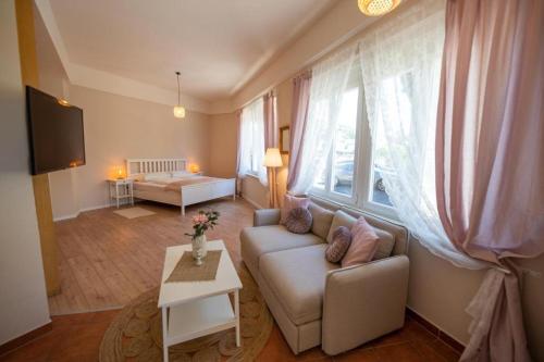 a living room with a couch and a table at Landhaus Appartements Gretl by S4Y in Krumpendorf am Wörthersee