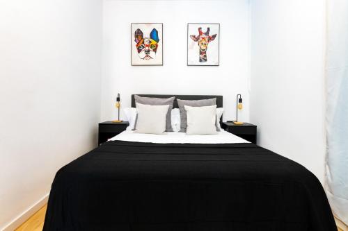 a bedroom with a black blanket on a bed at R&B Mila in Barcelona