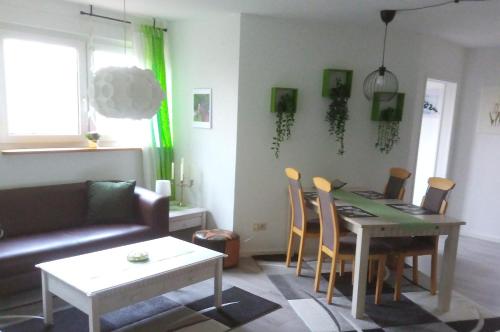 a living room with a table and chairs and a couch at Gemütliche Dachgeschosswohnung in Melle