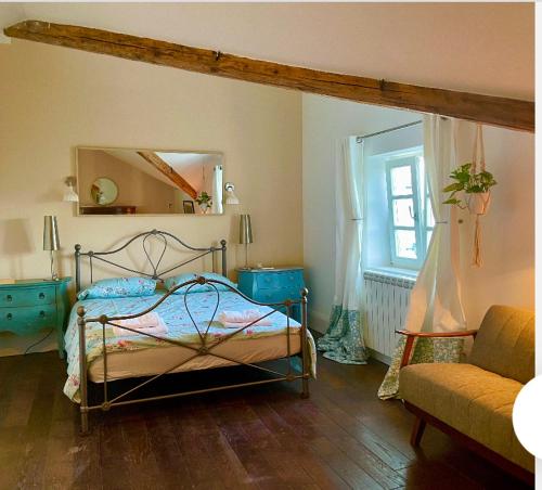 a bedroom with a bed and a mirror and a couch at The Olive Tree in Begovići