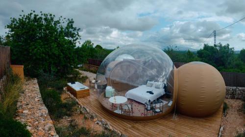 a dome house with a bed in it on a deck at Noches de Calig in San Jorge